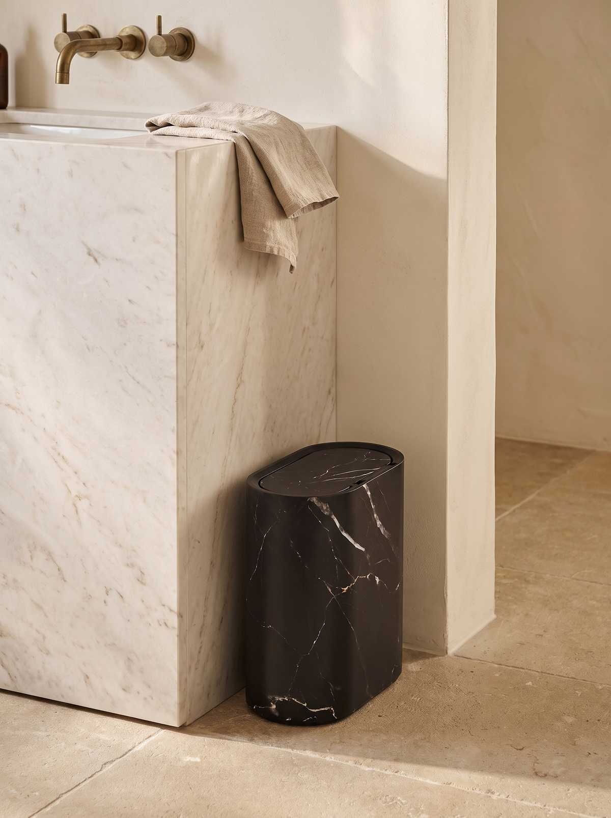 Carrera bin sitting flush in a narrow bathroom gap